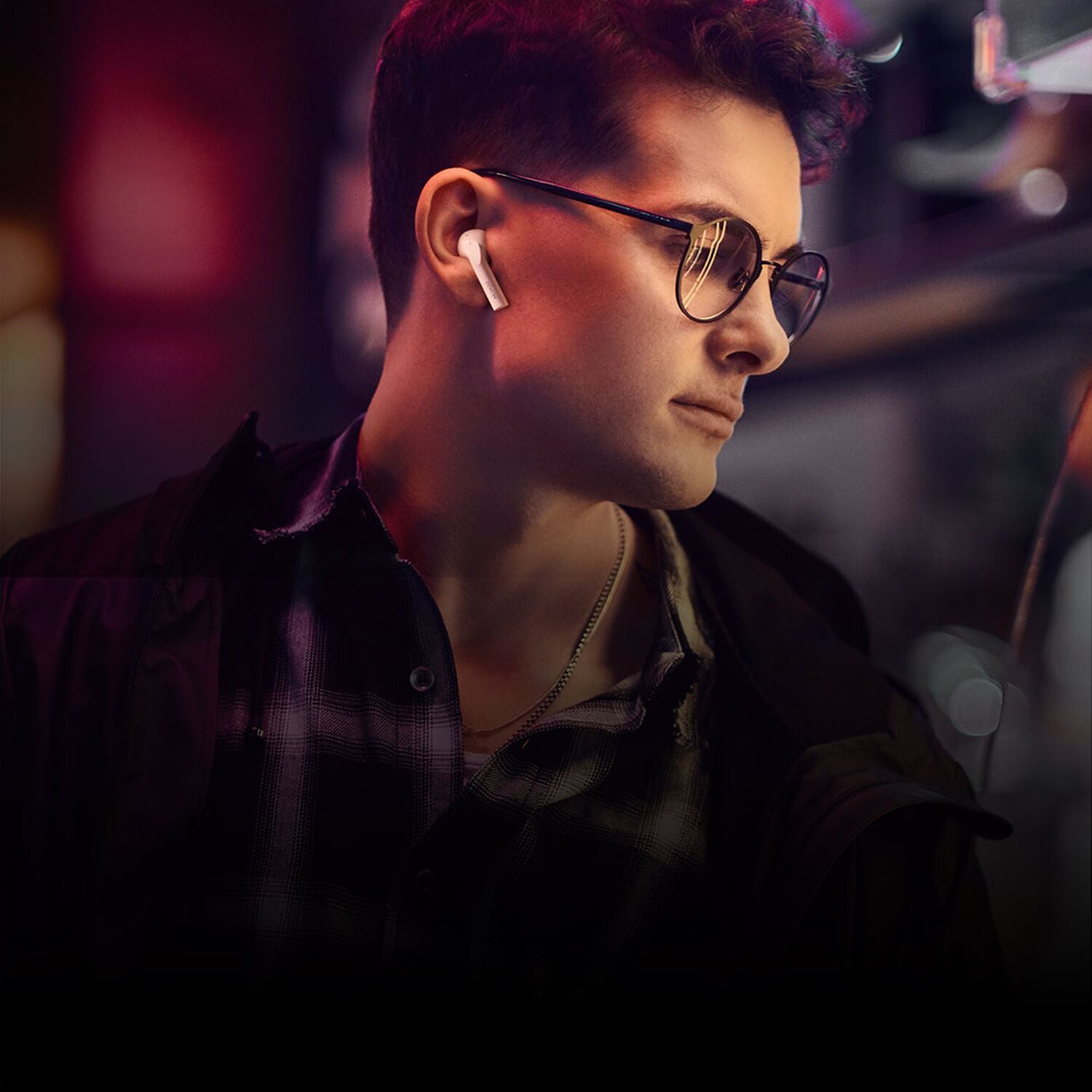 man listening to wireless earbuds