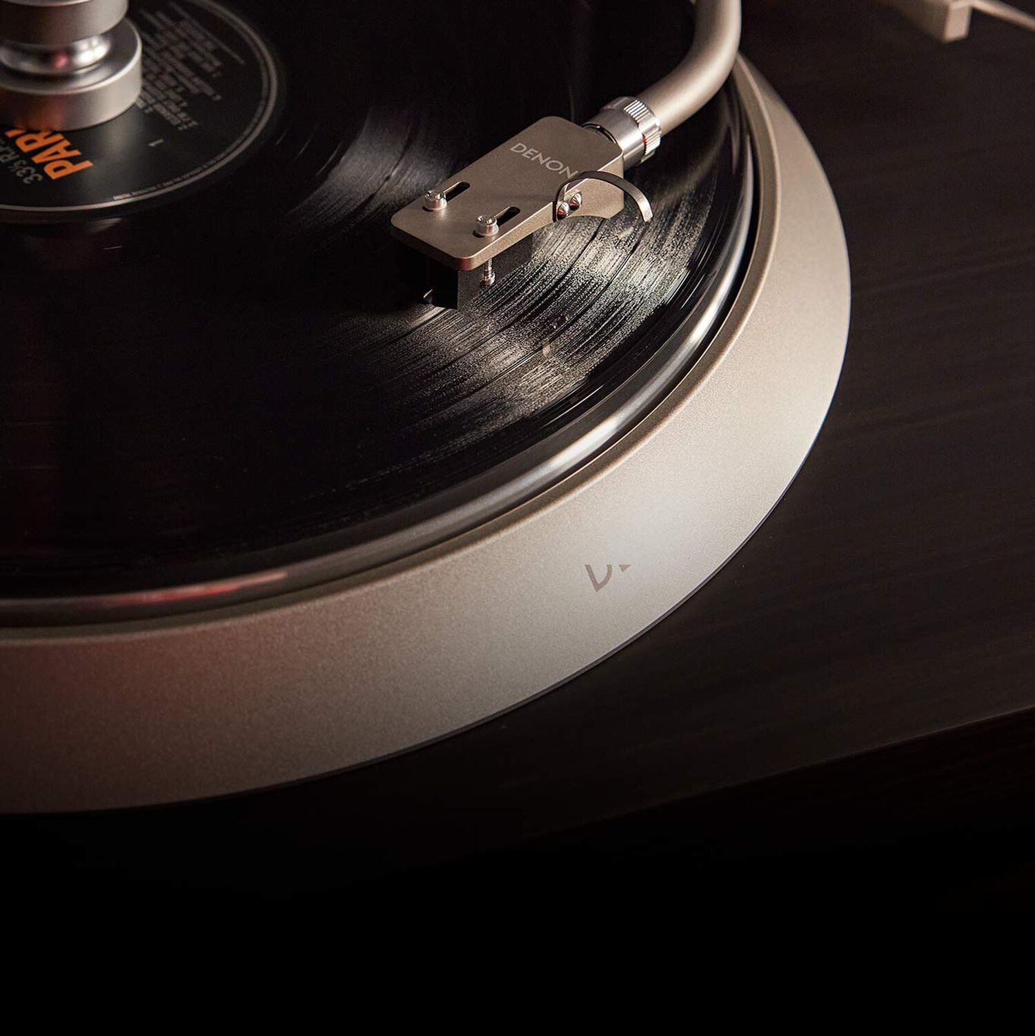 Close up of a turntable showing the cartridge