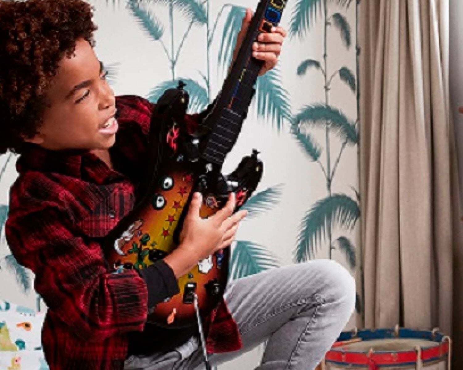 A kid playing a guitar