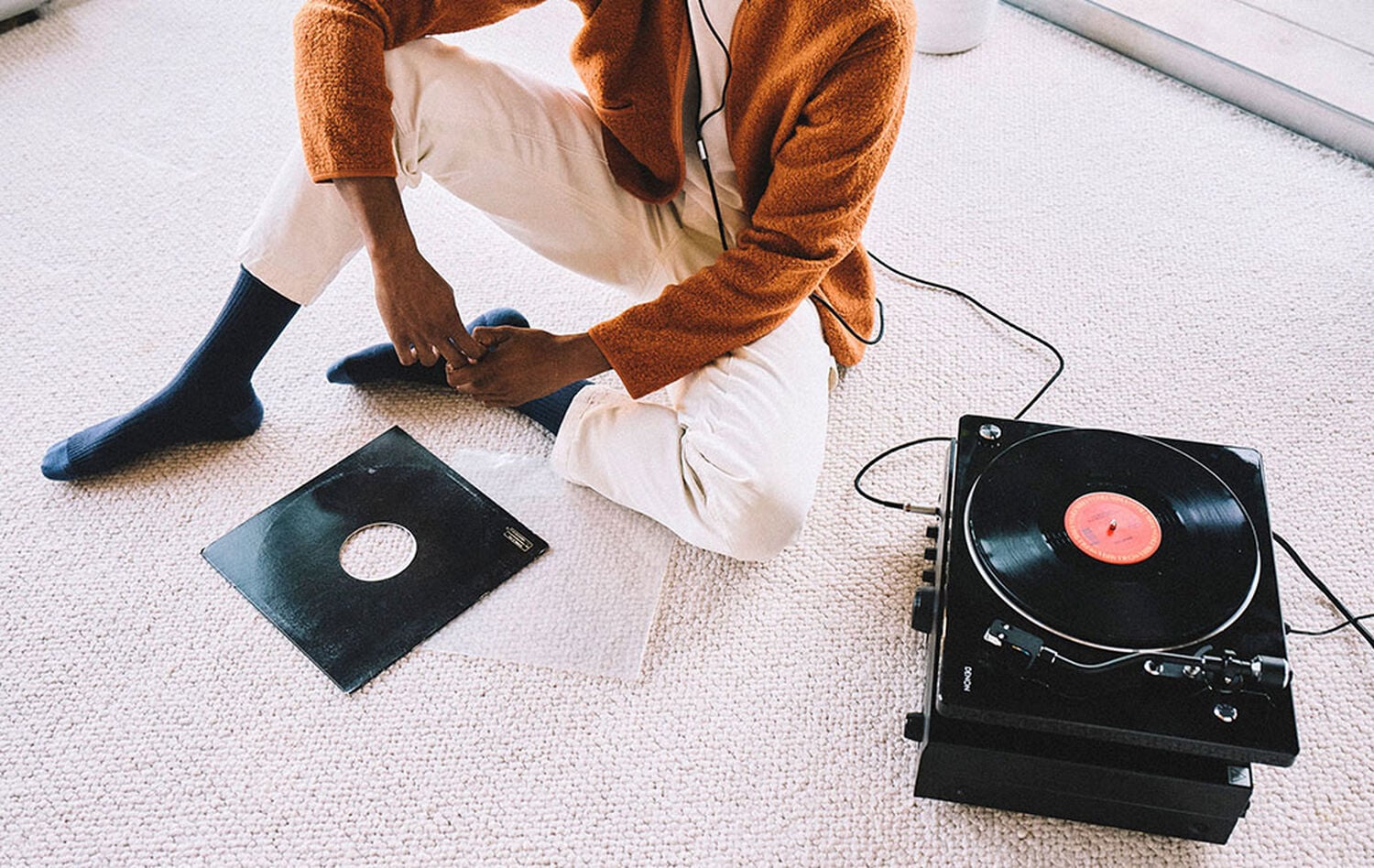 A man listening to a turntable