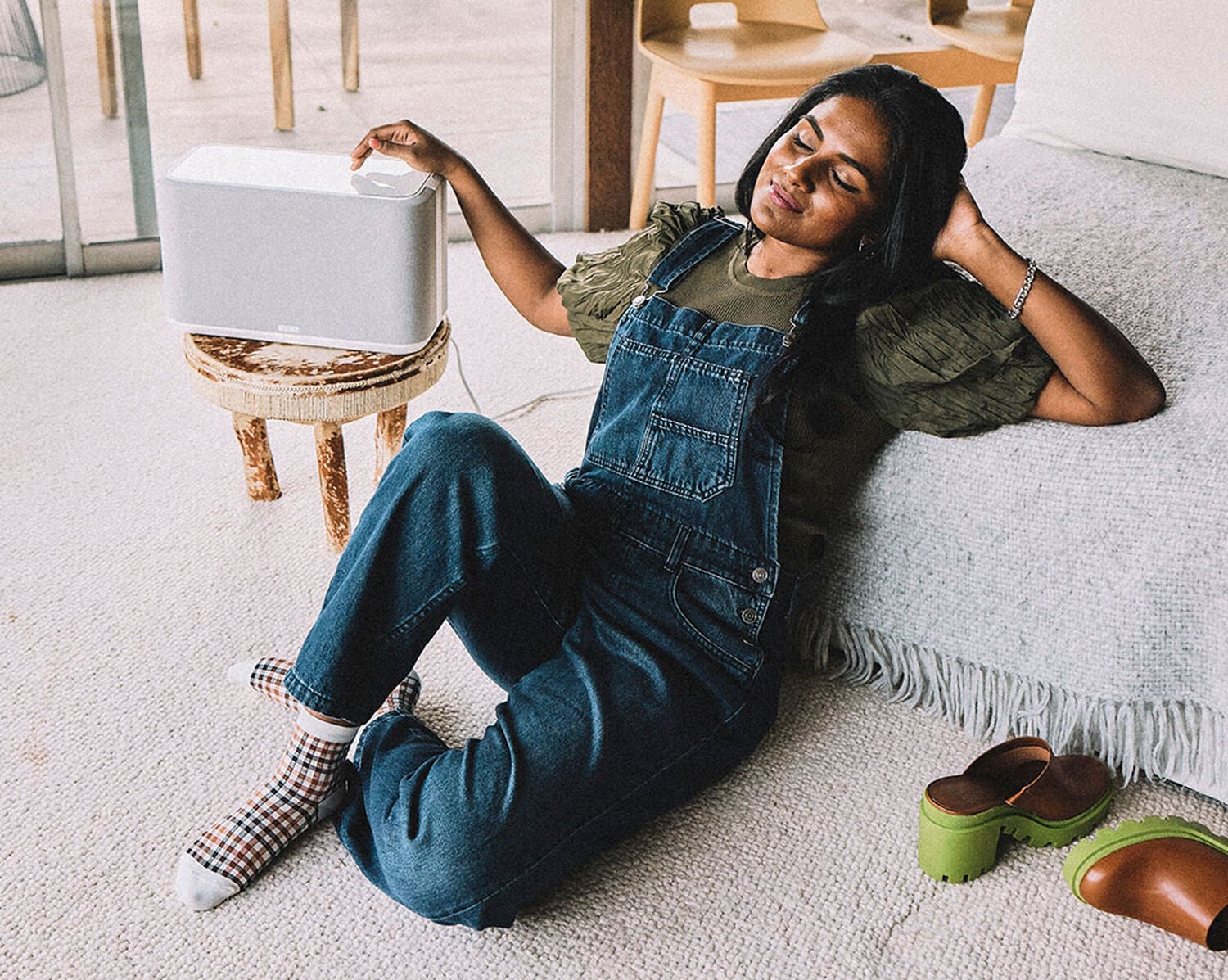A woman listening to music on a speaker