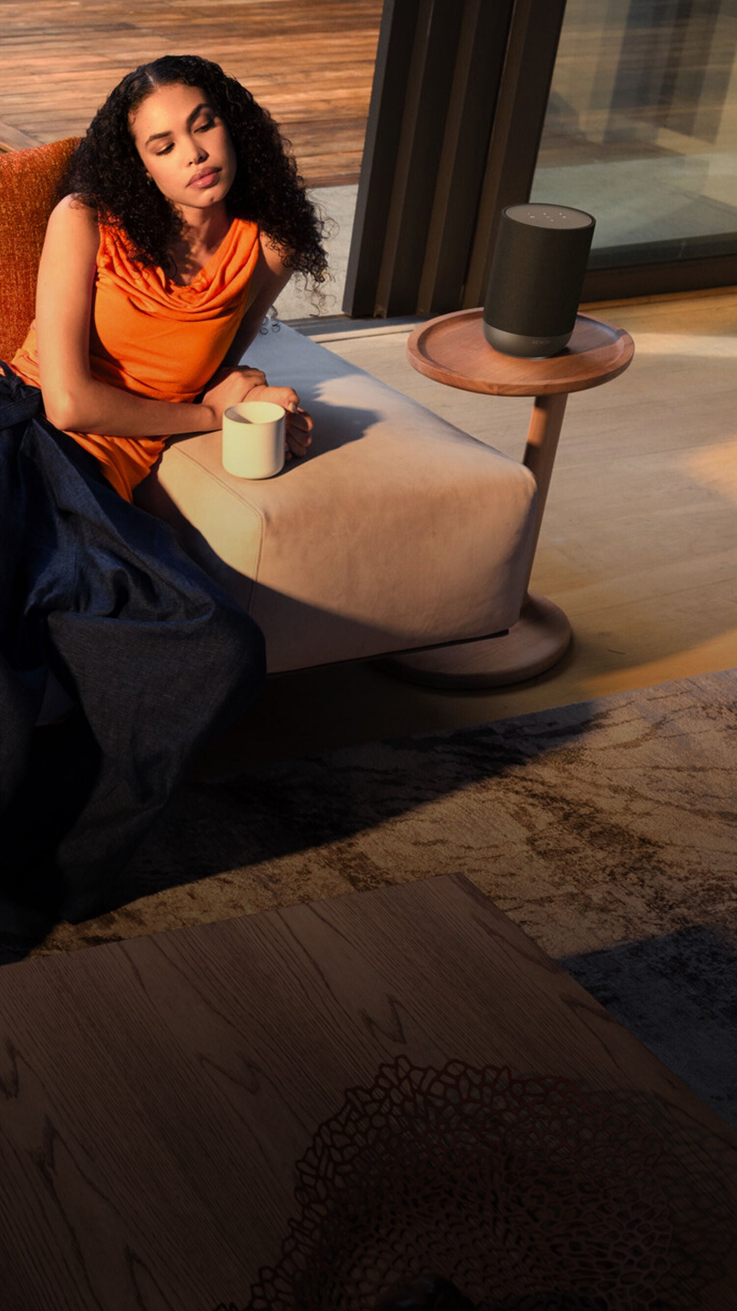 Woman with Mug Listening to Denon Home Speaker