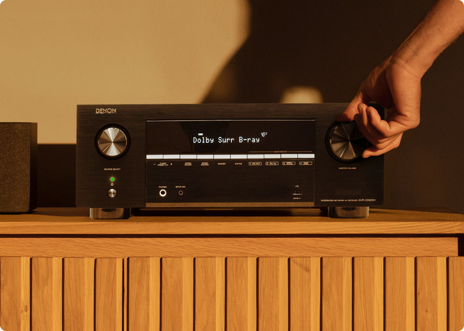 Someone turning a dial on the AVR-X3900H