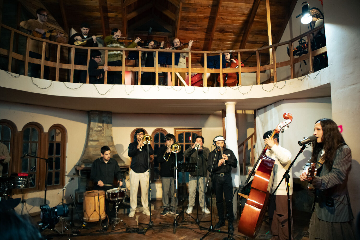 Javiera performing with a large band spread between two floors