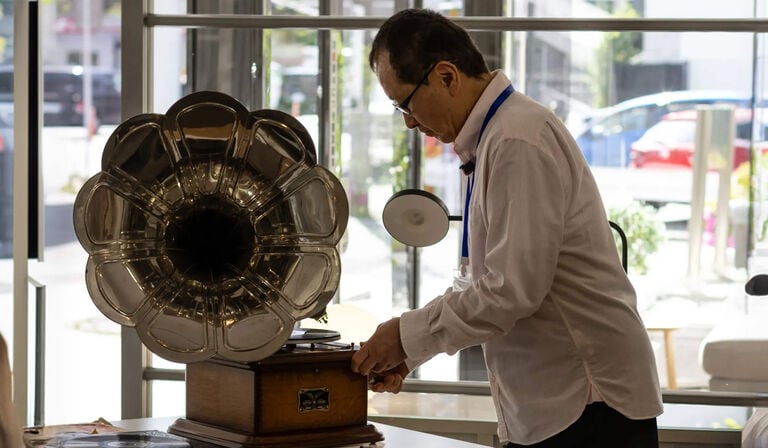A man adjusting a gramophone 