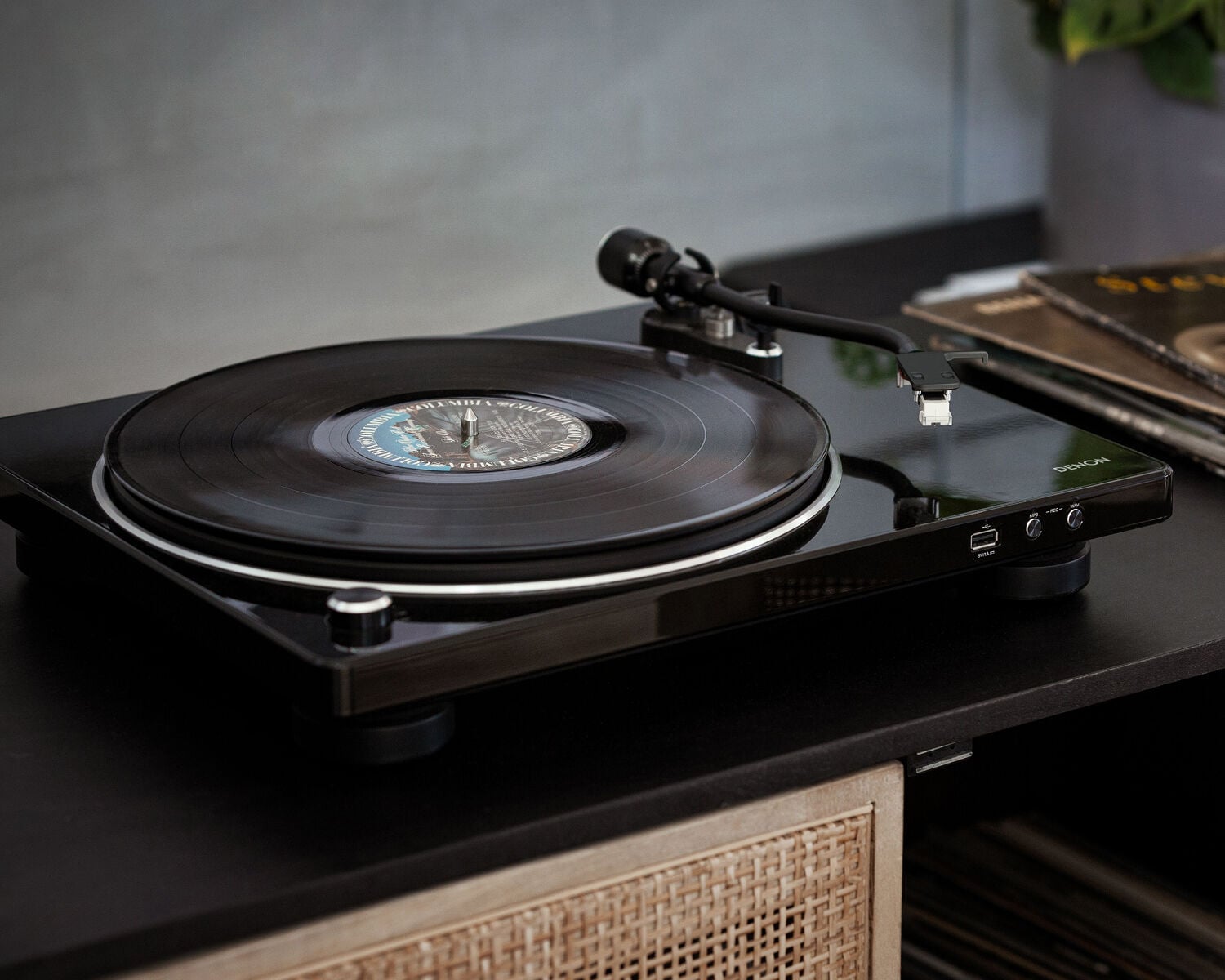 A Denon Turntable next to records