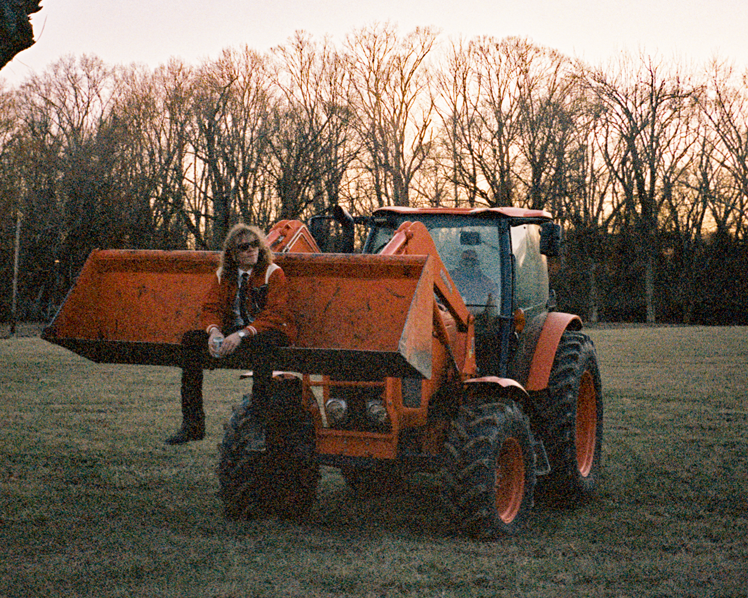 Mills sitting in the bucket of a front loader