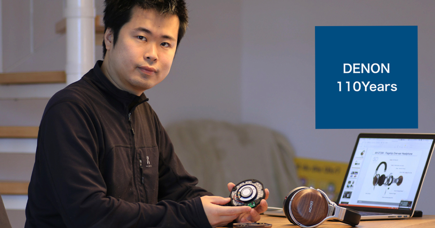 A man holding disassembled Denon Headphones
