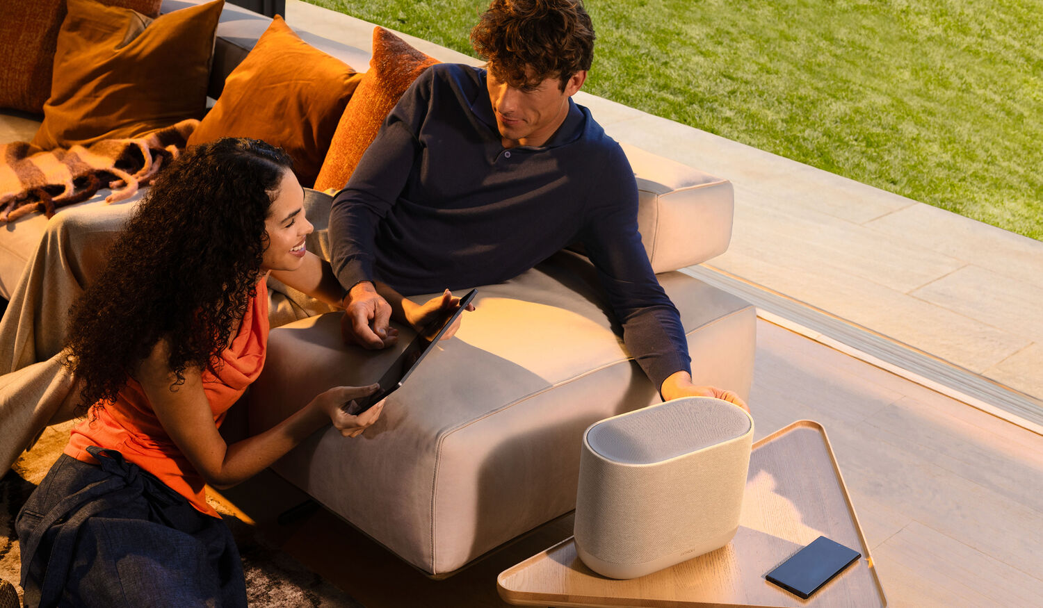 Friends gathered listening to music on a Denon Home system