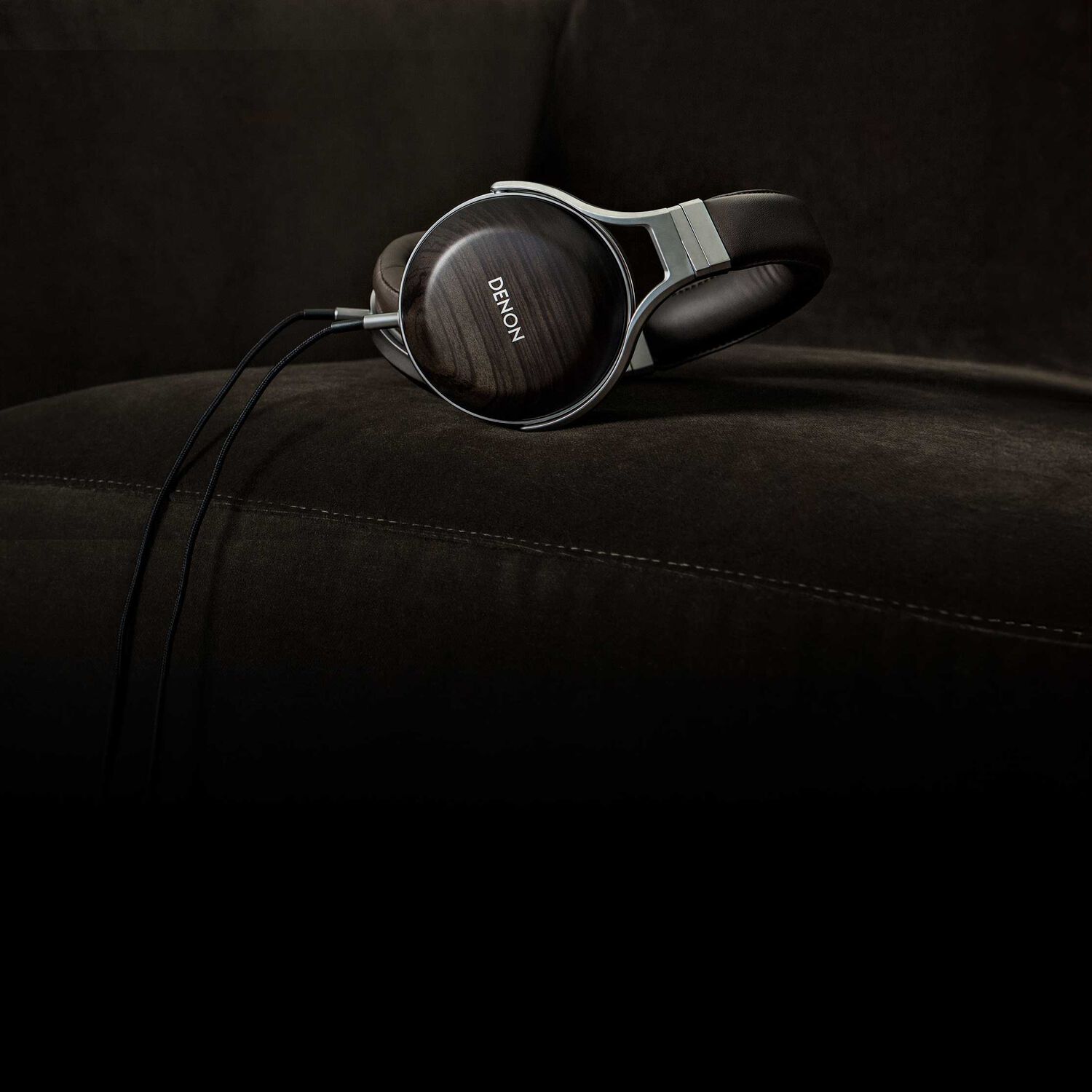 plugged-in headphones laying on a couch