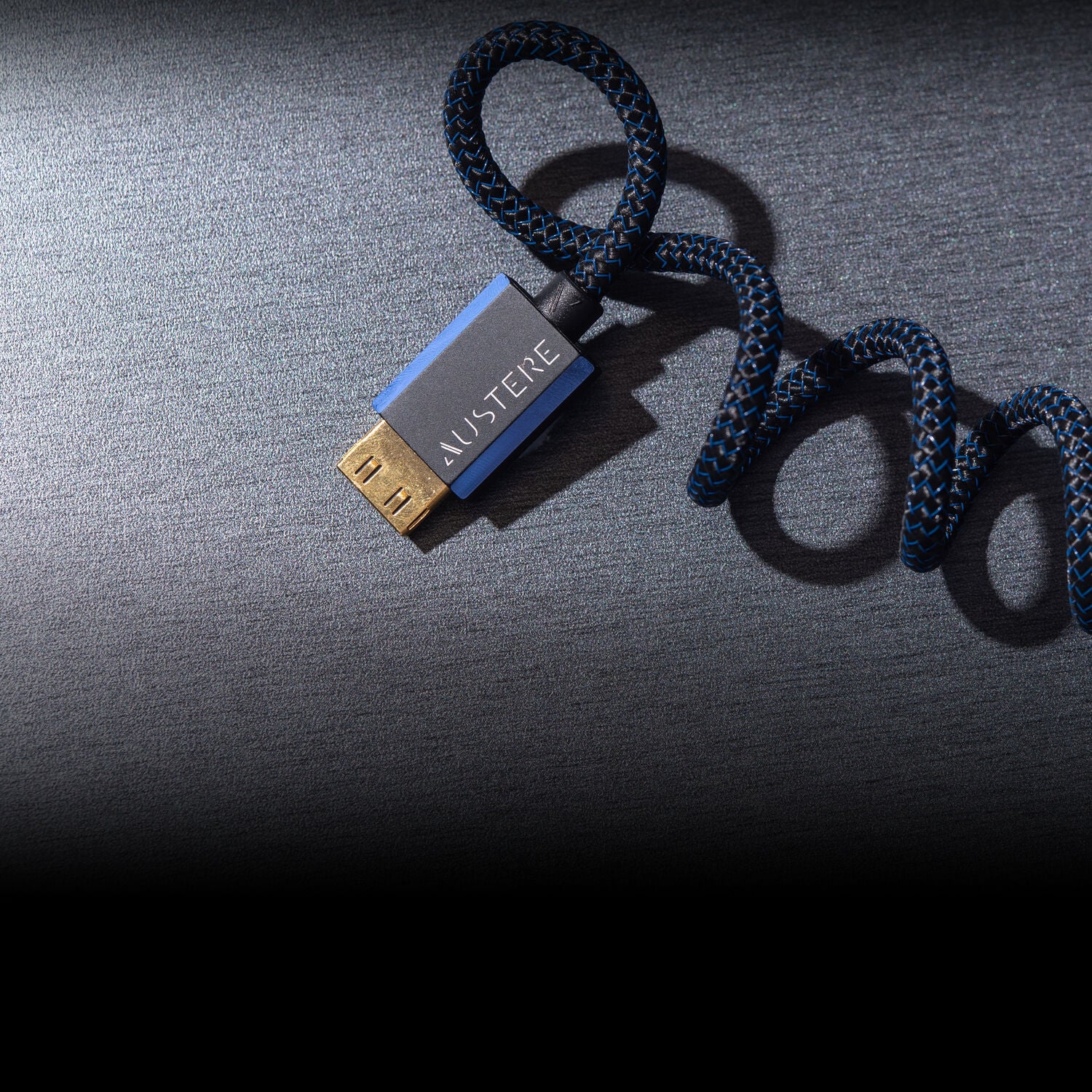 Austere Cables twisting together on a blue background